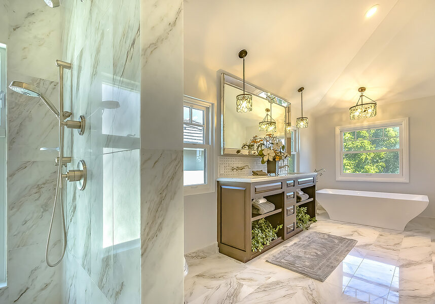 luxury bathroom with marble wall and floor decorated with chandeliers and plants